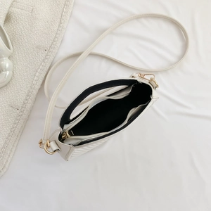 Quilted off-white saddle bag featuring golden metal hardware and a spacious interior
