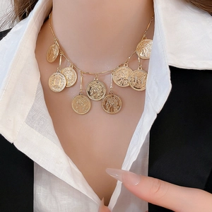 Detailed view of vintage gold layered coin necklace with classical relief engravings