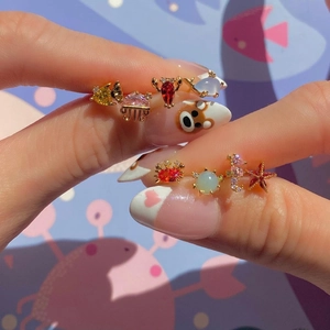 Colorful zircon marine life stud earrings featuring crab and starfish in gold plating