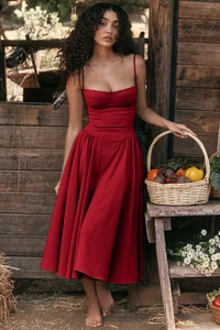 Detail of a red French vintage sundress with a corseted waist and flowing A-line skirt