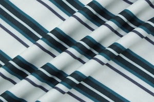 Close-up of honeycomb knit texture on striped fabric with green and white patterns