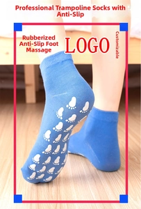 Close-up of blue trampoline socks with white anti-slip grips on a wooden floor