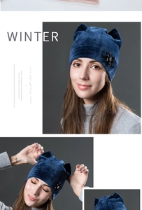 Detail of navy blue velvet winter hat featuring cute cat ears and a sparkling crystal bow