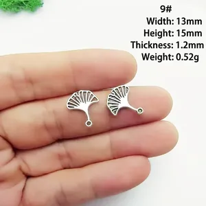 Silver ginkgo leaf pendant charms with detailed metallic texture and dimensions