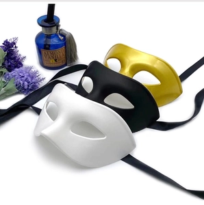 Three vintage masquerade half-masks in white, black and gold with black ribbon ties