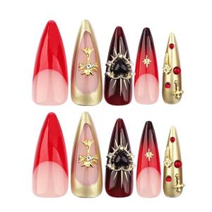 Gothic stiletto press-on nails with red gradient, gold crosses, and black heart gems