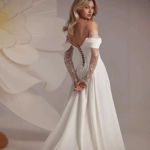 Elegant off-shoulder white lace wedding dress with long sleeves and a corset back design