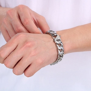 Silver 15mm Cuban link bracelet for men in polished stainless steel on a wrist