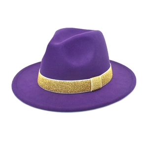 Detailed view of dark purple wool fedora hat featuring a sparkling gold glitter band decoration