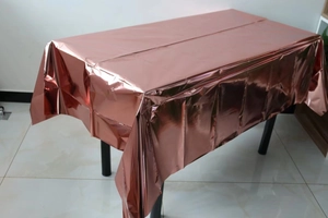 Detail of rose gold disposable foil tablecloth with a reflective metallic finish
