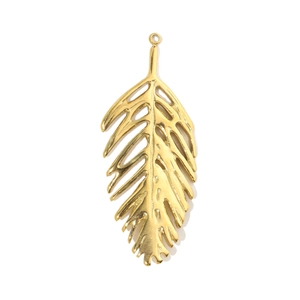 Close-up of golden hollow leaf pendant with hammered texture for DIY jewelry