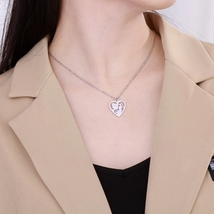 Close-up of mother and child silhouette heart pendant necklace worn on a khaki suit