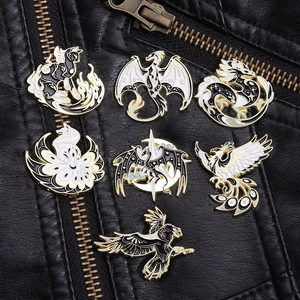 Detailed view of mythical beast enamel pins on a black leather jacket with gold metallic lines