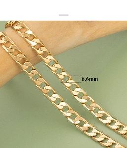 Detail showing 18K gold plated 6.6mm wide O-link chain textured on wooden prop