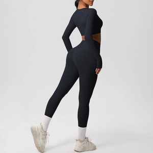 Detail of black seamless yoga set showing high-waisted leggings and long sleeve crop top