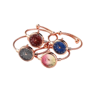 Set of four stylish wire band bracelet watches with crystal dials and faceted glass covers