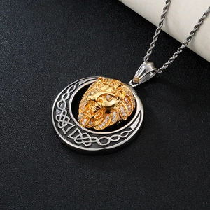 Macro shot of iced-out gold lion head pendant on a Celtic knot frame with rope chain