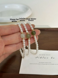 Detailed shot of pearls bracelets with Hetian jade beads in white, green, and celadon hues