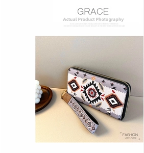 Detail of multi-color ethnic geometric pattern long zip-around wallet with wristlet strap