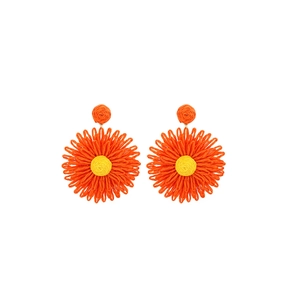 Close-up of handmade orange and yellow raffia flower earrings with woven texture details