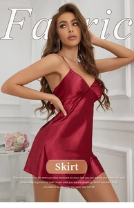 Detailed close-up of red silk satin fabric texture and V-neck of the sleek slip dress