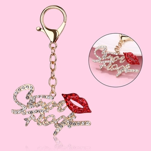 Golden crown and sexy letter keychain with red rhinestone lips on pink background