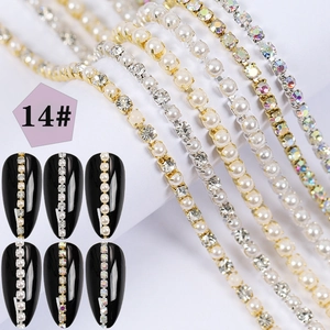 Detail shot of pearl and rhinestone nail art chains with gold and silver metal bases