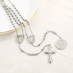 Detailed view of silver stainless steel rosary necklace with cross and religious medal