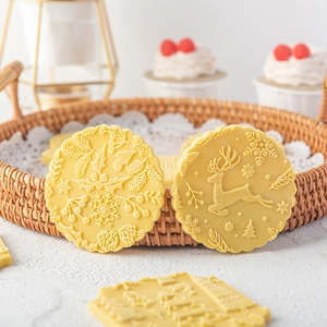 Christmas themed embossed rolling pin patterns on cookies featuring deer and snowflakes