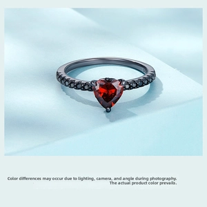 Macro shot of 925 sterling silver S925 engraving on a black heart ring with red zircon