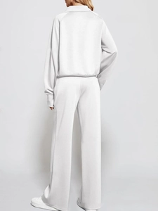 Rear view of white two-piece lounge set featuring a half-zip sweatshirt and wide-leg pants