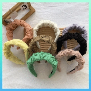 Flat lay of colorful coral fleece bow headbands in pink, white, and purple options
