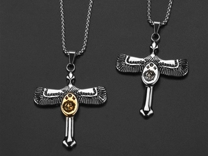 Detail of vintage eagle cross pendants with gold and silver centers on black background