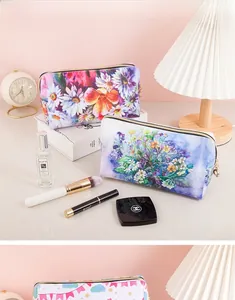 Close-up of floral print toiletry bag with golden zipper in a stylish home setting