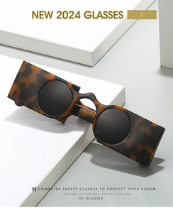 Close-up of retro square tortoise shell frame with round black lenses on white blocks