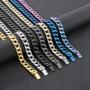 Detail of 15mm cuban link chains in gold, silver, and black on cylindrical displays