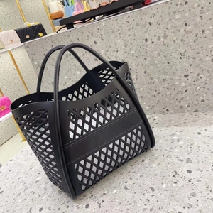 Close-up of black hollowed-out jelly tote bag with honeycomb mesh texture and dual handles