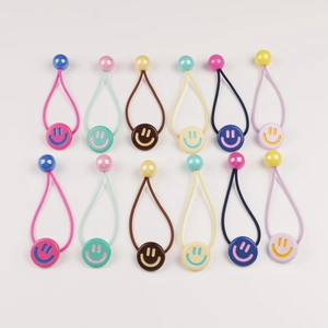 Set of 12 colorful smiley face hair ties in assorted pastel colors on a white background