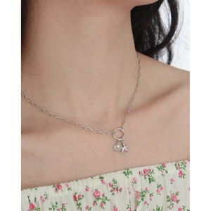 Silver necklace featuring shell and starfish pendants with a pearl and tiny diamonds
