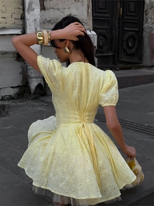 Yellow cotton broderie anglaise mini dress with puff sleeves and lace-up back detail