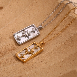 Detail of gold and silver North Star tarot necklaces with mother of pearl inlay
