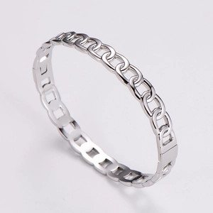 Detailed macro view of silver stainless steel chain link bracelet with polished finish