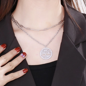 Double-layered silver necklace featuring a hollow Tree of Life pendant on a paperclip chain