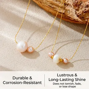 Detailed view of irregular white and pink pearls on a gold stainless steel chain