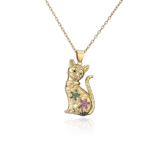 Detail of gold plated cat pendant with colorful zircon stones and star moon motifs