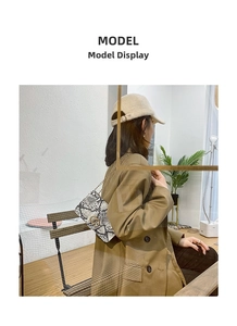 Model view of a vintage faux snakeskin crossbody bag with golden interlocking rings