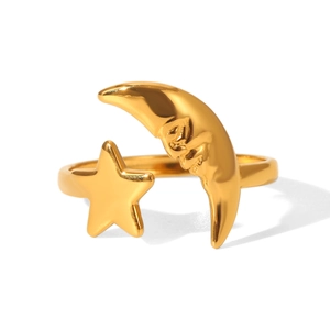 Detailed view of 18K gold star and moon open ring with adjustable polished steel band