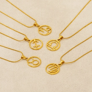 Gold titanium steel 12 zodiac constellation pendant necklaces on beige sand background