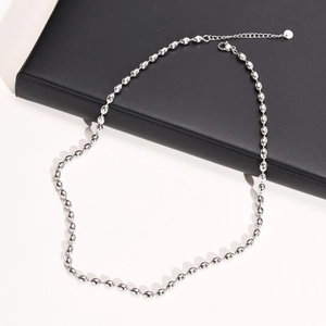 Detail of silver titanium bead necklace with adjustable clasp and small round tag