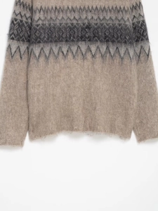 Detail view of Fair Isle knitted sweater with fuzzy mohair texture and geometric patterns